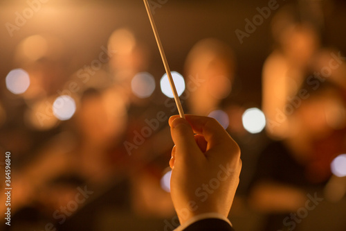 Close up of orchestra conductor holding baton photo