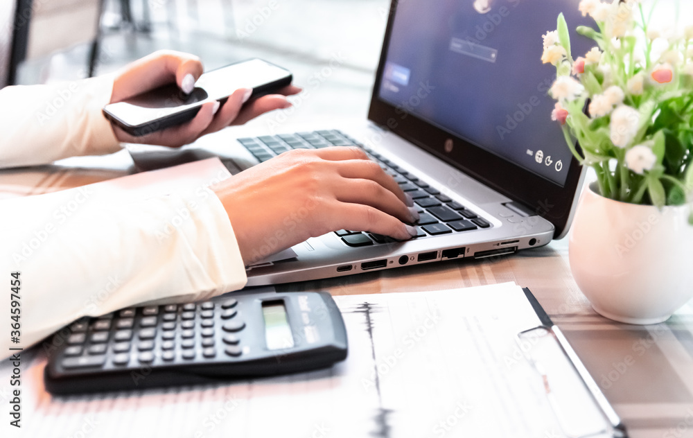 Businesswoman is working with documents and laptop at a cafe, selective focus Businesswoman is working with documents and laptop at a cafe, selective focus