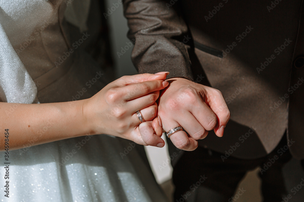 The hands of the newlyweds, which wearing wedding ring