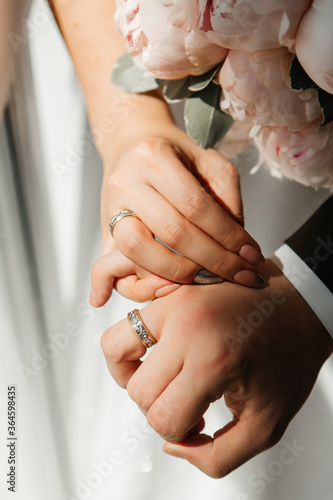 The hands of the newlyweds, which wearing wedding ring