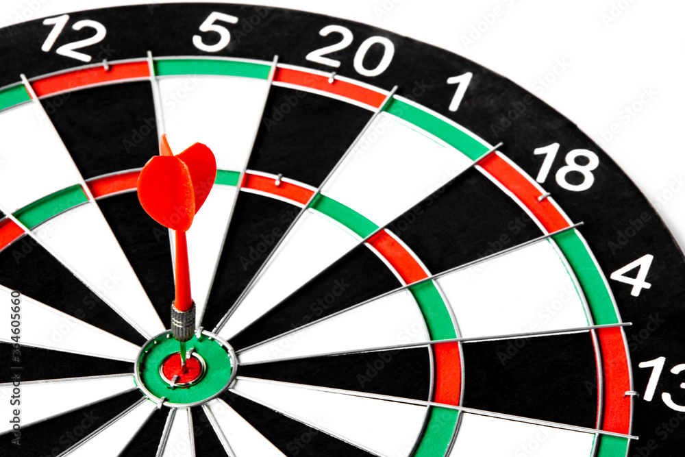 Close up shot red dart arrow on center of dartboard, metaphor to target success, winner concept, Isolated on white background with clipping path