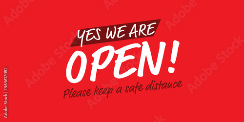 Yes we are open please keep a safe distance banner on red background