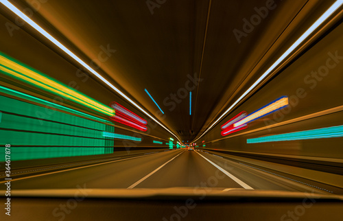 underground car tunnel with light trails and leading lines.