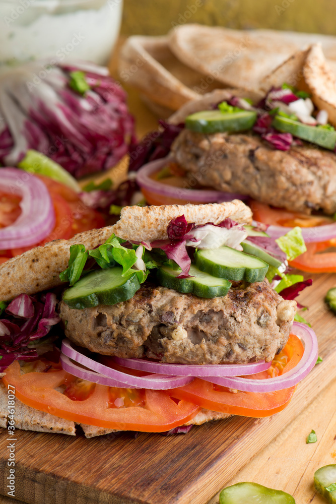 Hamburger made with lamb meat. Lamb burger. Classic traditional greek variation of the classic american burger tradition. seasoned lamb meat with feta cheese, red onion and greek mayo. Hamburger made with lamb meat. Lamb burger. Classic traditional greek variation of the classic american burger tradition. seasoned lamb meat with feta cheese, red onion and greek mayo.