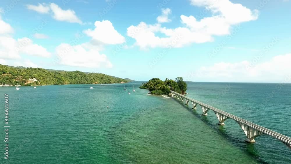 Flying next to a bridge towards sailboats over beautiful Caribbean waters Flying next to a bridge towards sailboats over beautiful Caribbean waters
