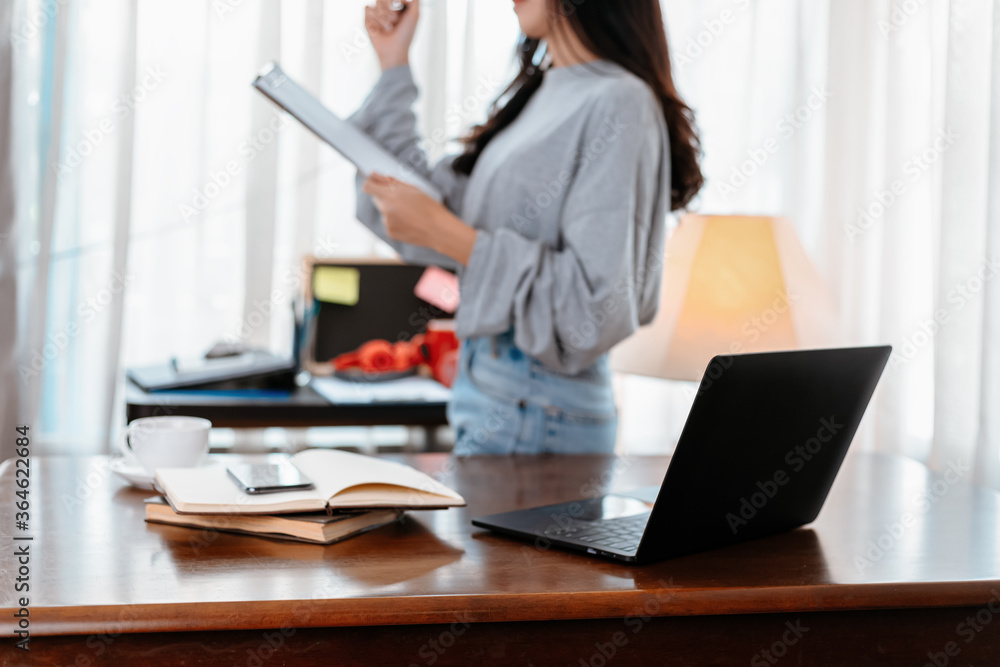laptop on the table and student hold documant background. Student learning at home. laptop on the table and student hold documant background. Student learning at home.