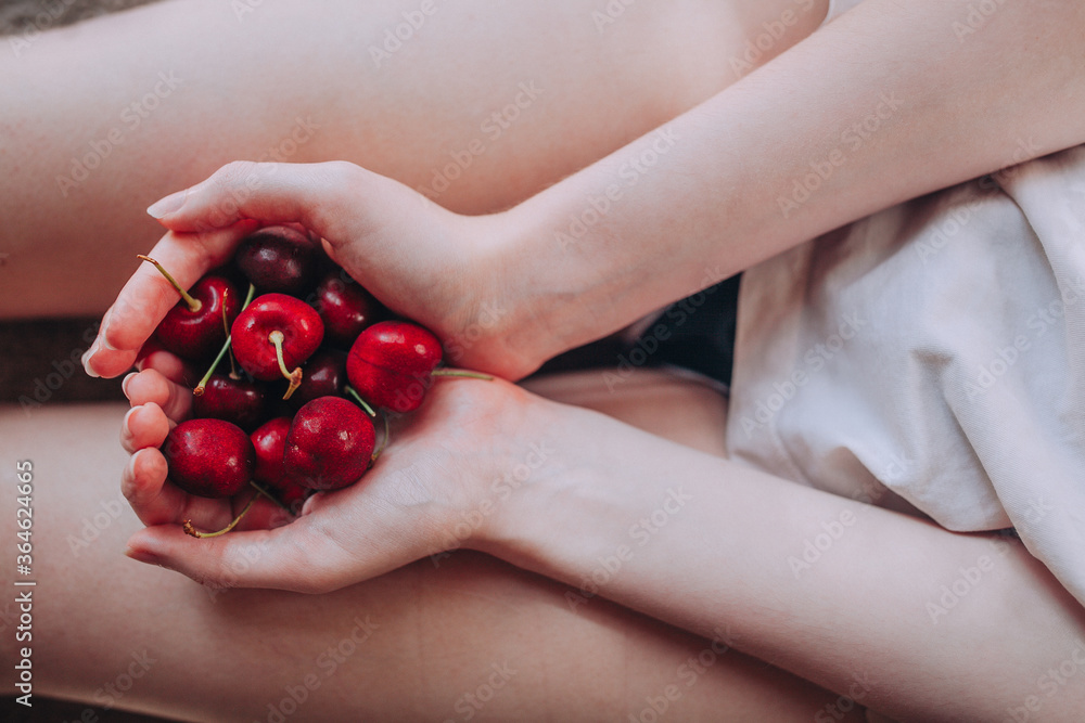 girl holds a handful of cherries girl holds a handful of cherries