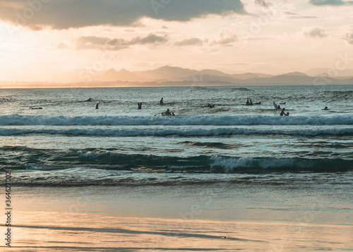 Surfers waiting for the waves at sunset