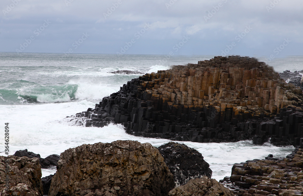 The Giant's Causeway is an area of about 40,000 interlocking basalt columns, the result of an ancient volcanic fissure eruption. It is located in County Antrim on the north coast of Northern Ireland The Giant's Causeway is an area of about 40,000 interlocking basalt columns, the result of an ancient volcanic fissure eruption. It is located in County Antrim on the north coast of Northern Ireland