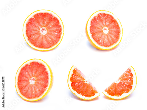 Close up of a sliced fresh grapefruit  Slice of red grapefruit isolated on white background