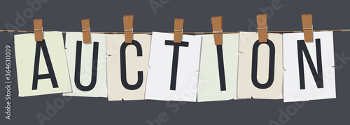 Word "Auction" attached with hairpins