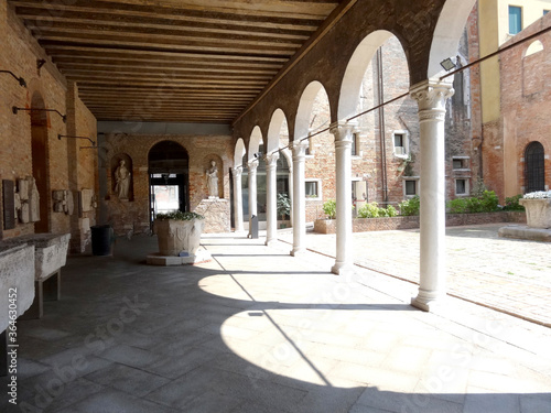 venetian palazzo courtyard with arches and colonnade photo