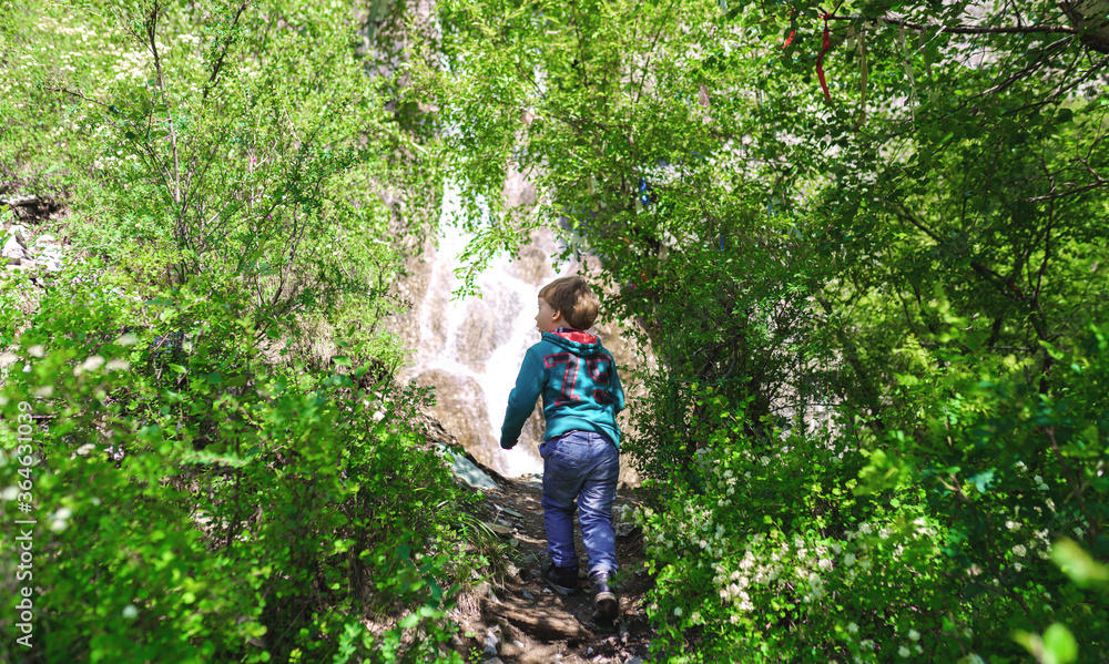 enthusiastic child goes to the waterfall enthusiastic child goes to the waterfall