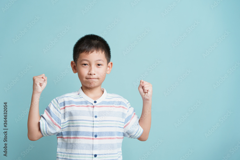 Portrait. Asian happy little boy standing on blue background isolated Portrait. Asian happy little boy standing on blue background isolated