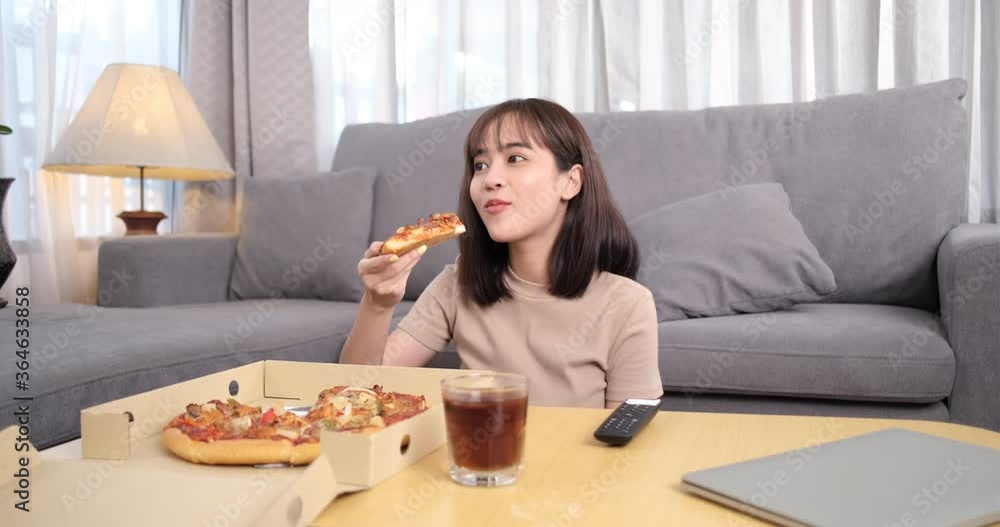 Young asian woman takeaway junk food eating pizza with drinks cola. Young asian woman takeaway junk food eating pizza with drinks cola.