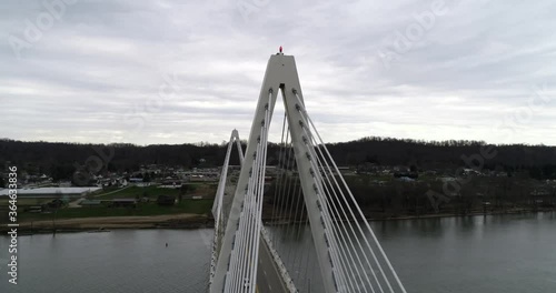 Aerial drone video orbiting around one of two large cable towers holding up a bridge over the Ohio river photo