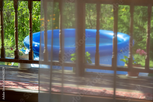 Inflatable blue pool in the backyard of a private house.