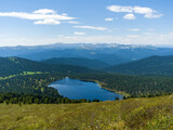The view from the top of the mountain. Light Lake in the Ergaki Nature Park. Panorama of the distant Siberian mountains