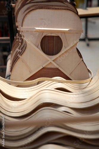 Guitar factory showing raw wood and guitars in the different stages of creation.
