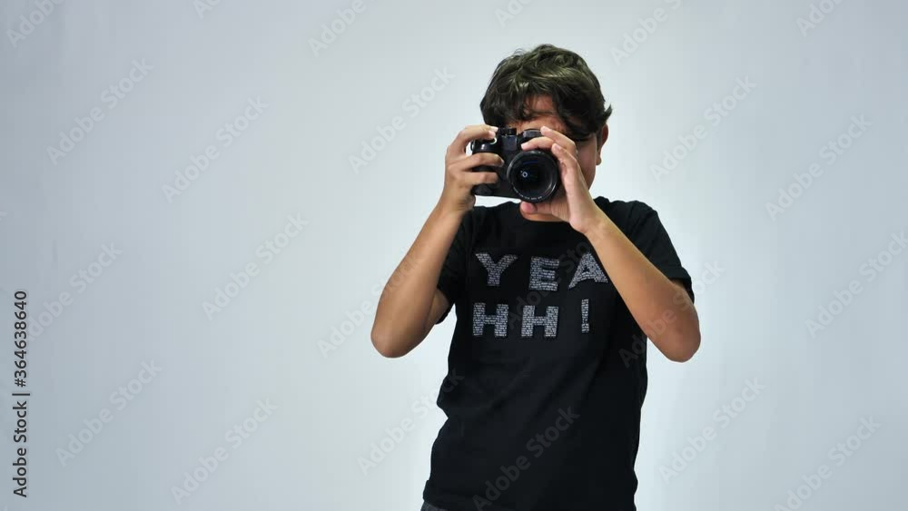 cute kid with a camera taking pictures on a white backround cute kid with a camera taking pictures on a white backround