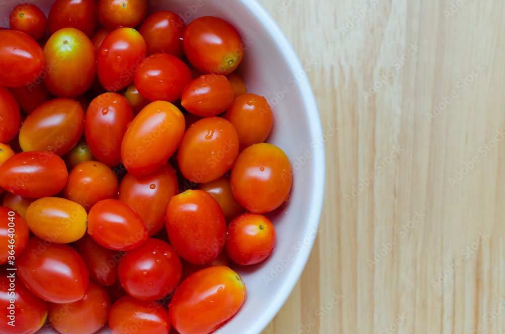 Red Cherry Tomatoes in White Ceramic Bowl is Ready to Cook. Red Cherry Tomatoes in White Ceramic Bowl is Ready to Cook.
