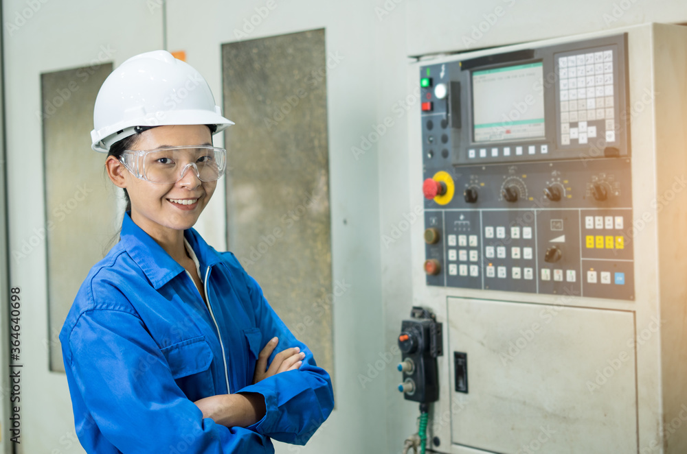 Portrait of beautiful young woman technician in hardhat smiling confidently and crossed her arms at camera enjoying work in modern factory, Technology smart working. Industrial working concept Portrait of beautiful young woman technician in hardhat smiling confidently and crossed her arms at camera enjoying work in modern factory, Technology smart working. Industrial working concept