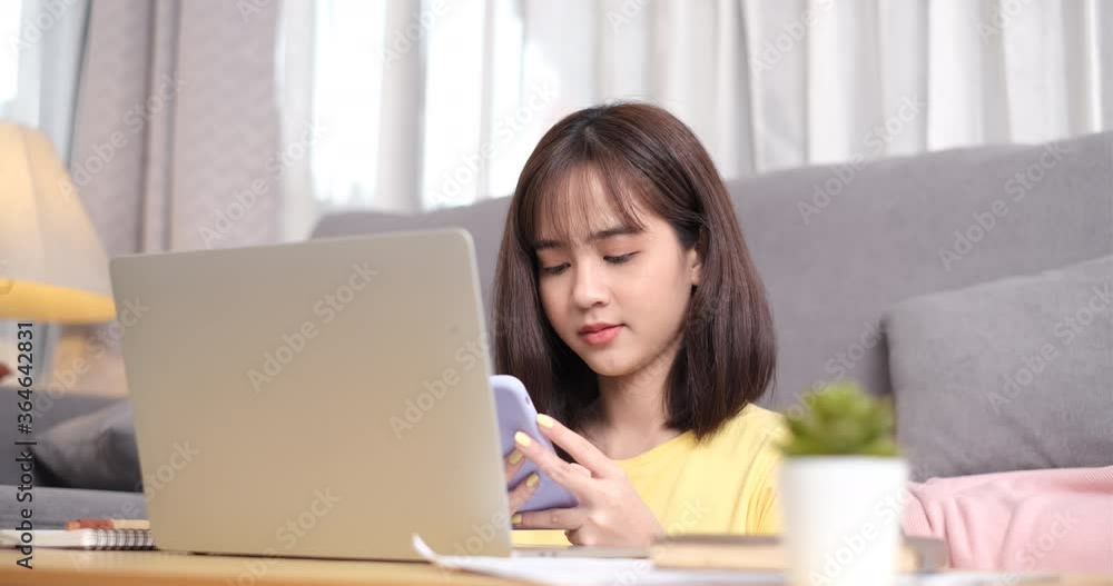 Young asian woman working on laptop computer and using cellphone. Young asian woman working on laptop computer and using cellphone.