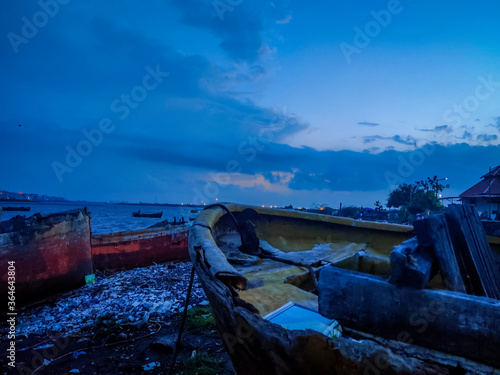 A View Of Sunset On A Beach With Vintage Boats And Blue Sky. © Jaynesh