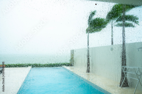The storm is coming At the private resort there is a pool and by the sea.