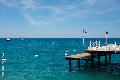 Pier on the shore of the blue sea