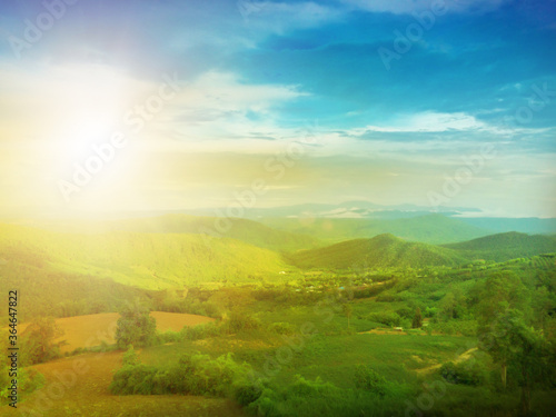 Panorama of thailand country at sunset in evening light. Wonderful springtime landscape on mountains. Grassy field and nature. Rural scenery mountain valley during sunrise. Natural summer landscape. © Phokin