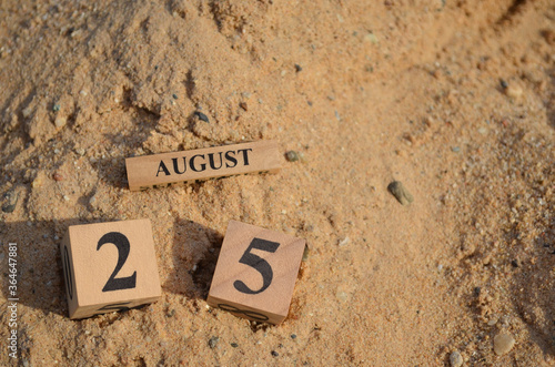 August 25, Number cube with Sand pile for a background.