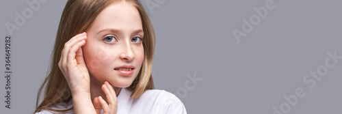 Beauty girl portrait. Young woman. Hand near nead. Face massage concept. White shirt. Cosmetology facelift laser. Medical rejuvenation scrub. Skin care hygiene. Grey background. Horizontal banner