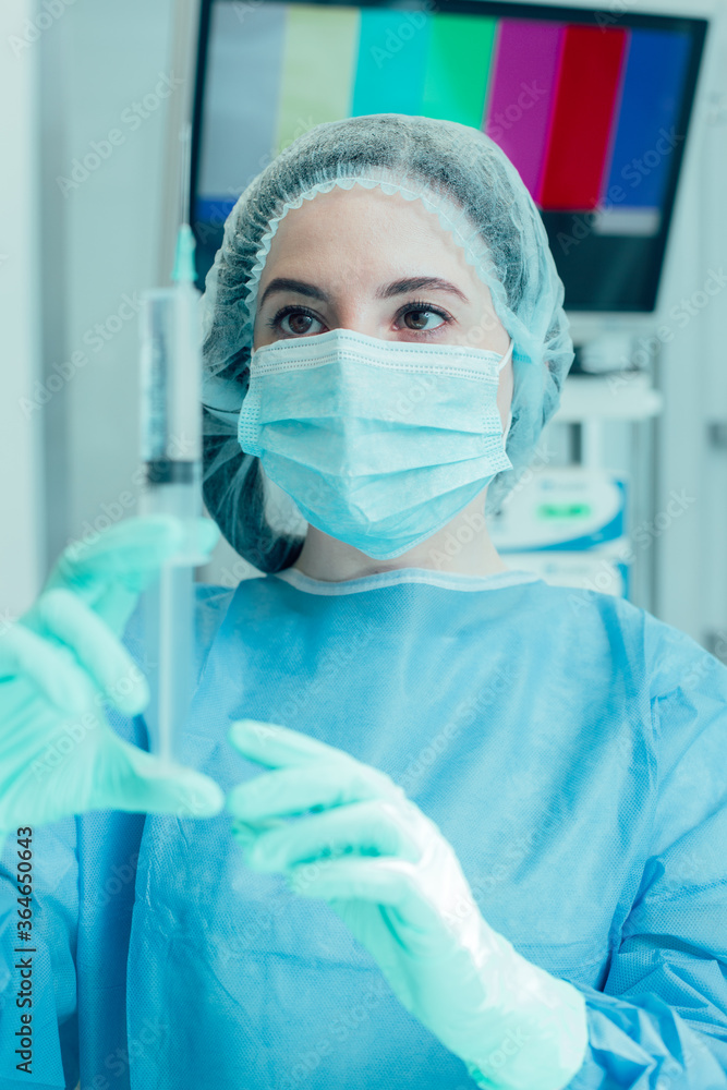 Concentrated medical worker preparing the injection for her patient Concentrated medical worker preparing the injection for her patient