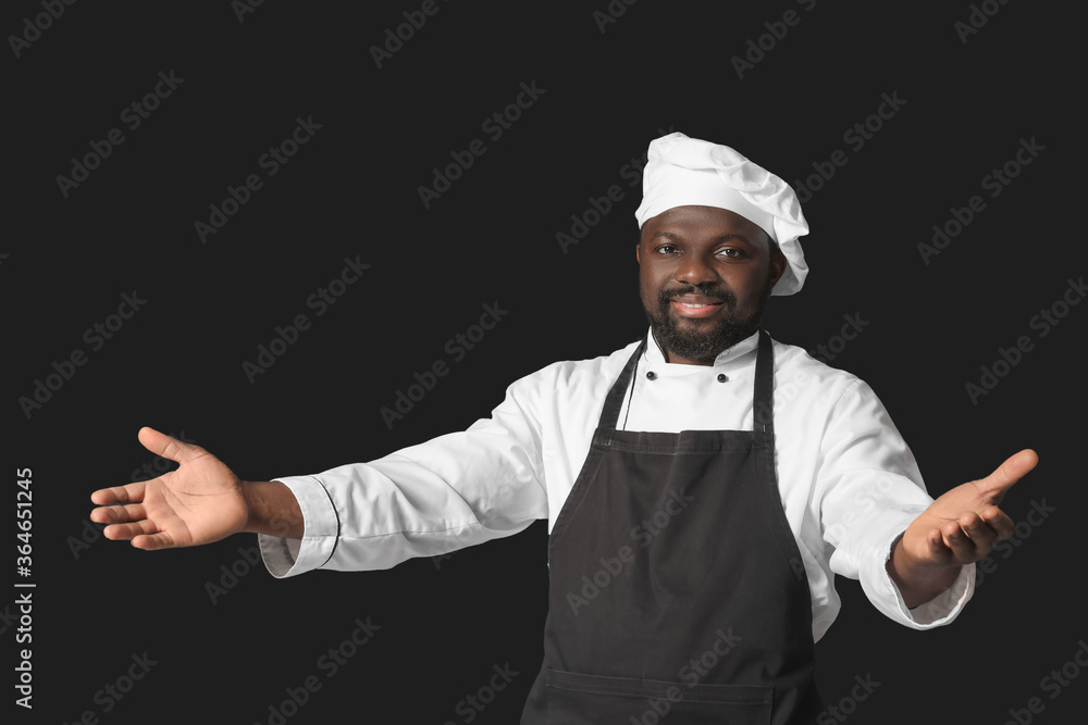 Male African-American chef on dark background Male African-American chef on dark background