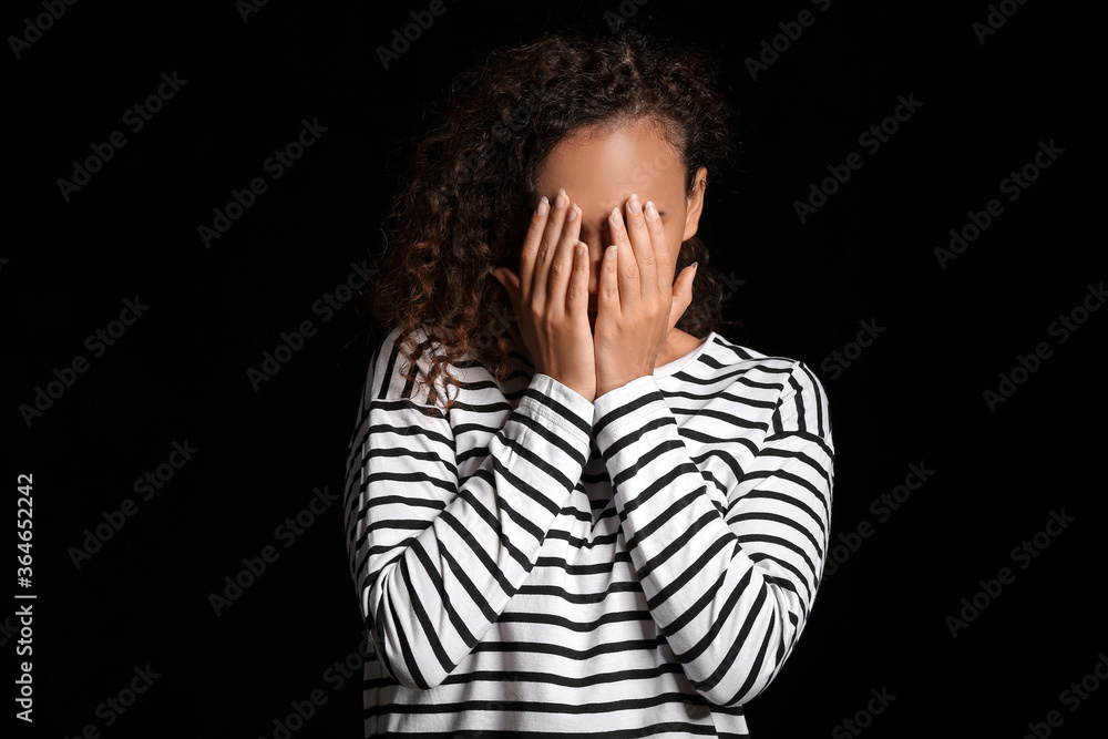 Sad African-American woman on dark background. Stop racism Sad African-American woman on dark background. Stop racism