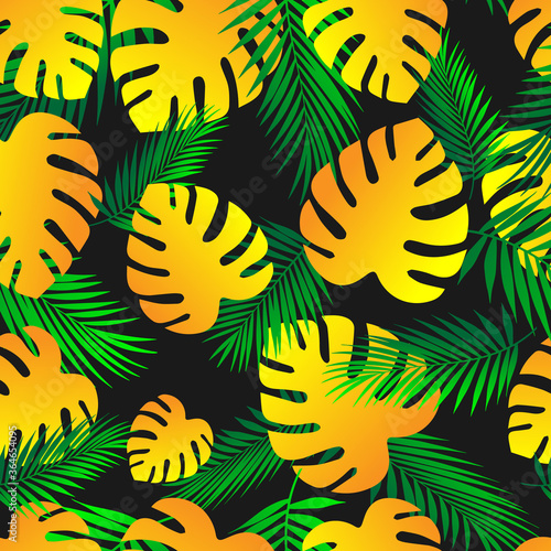Palm leaves.Tropical pattern of green and yellow leaves on a black background. Seamless pattern background