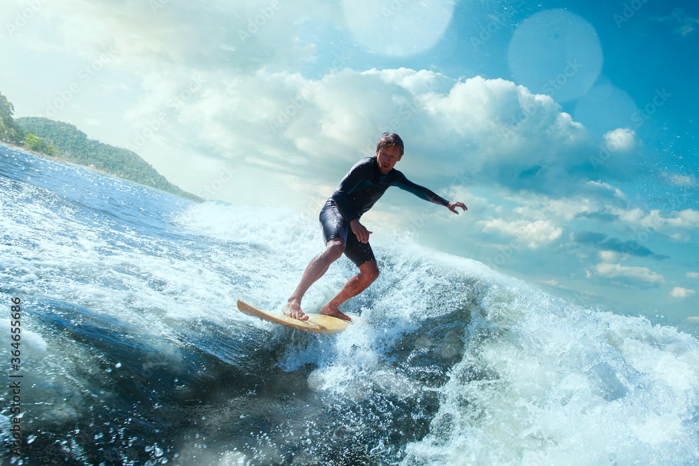 Surfer on Blue Ocean Wave Getting Barreled. 