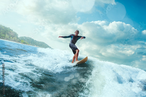 Surfer on Blue Ocean Wave Getting Barreled. 