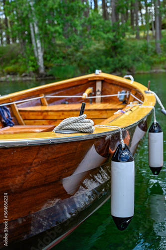 old well-managed wooden boat in lake in Sweden photo