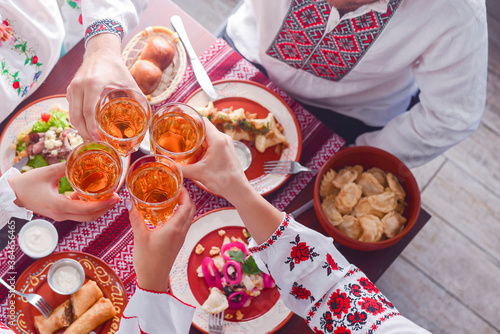 Ukrainian family in traditional closes has a dinner together. Ukrainian culture. Ukraine concept. Holiday concept.
