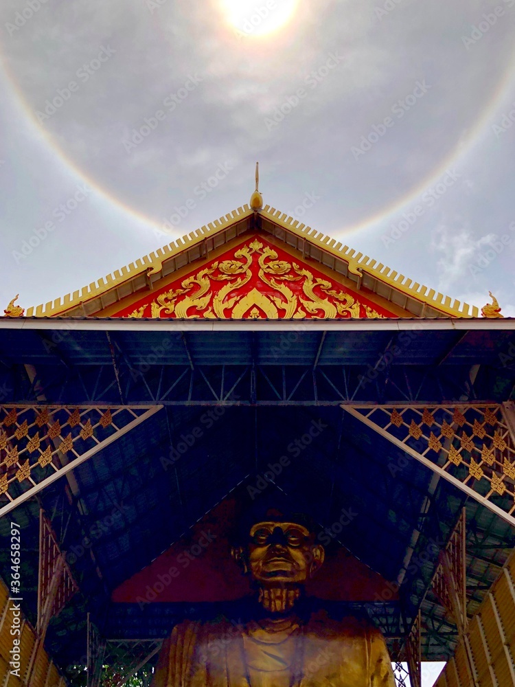 The sun halo. Above the roof of a temple in Bangkok The sun halo. Above the roof of a temple in Bangkok