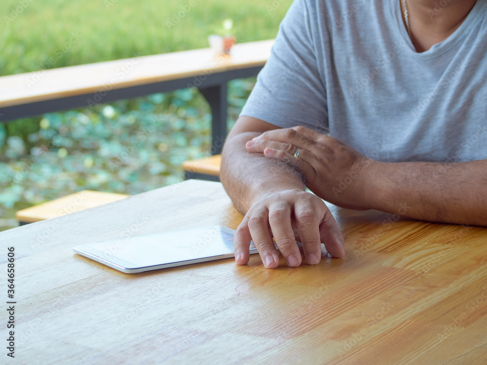 Man using tablet in outdoor park. Man using tablet in outdoor park.