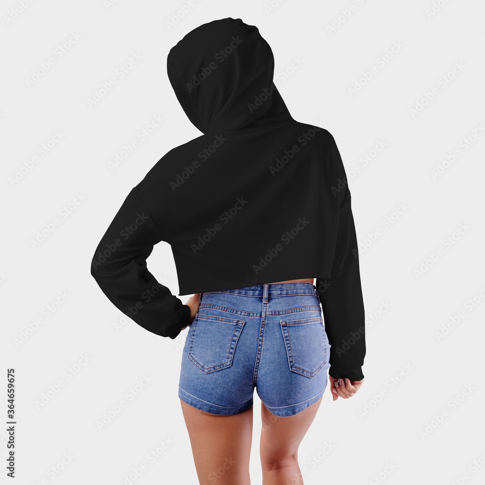 Mockup black crop top on a girl in a hood with a hand on her belt
