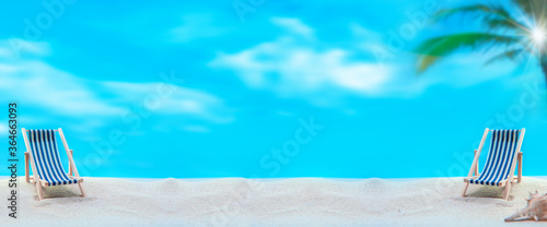 Deck chairs on summer beach background. Social distancing for seat at least 2 metres or 6 feet away from other. photo