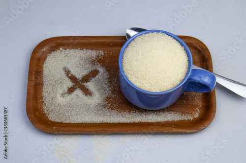 White Sugar in a cup with spoon  diabetes concept