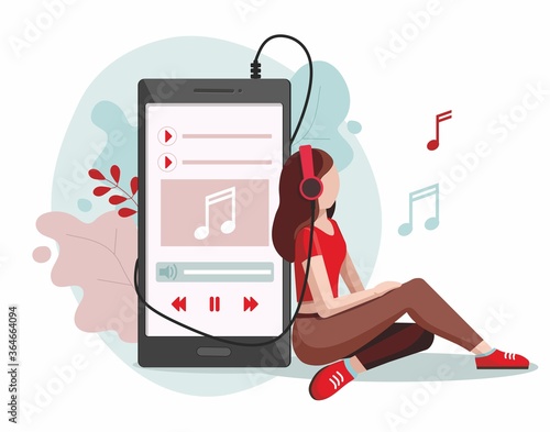 Young girl wearing headphones. Girl listening to music with mp3 player and smartphone.