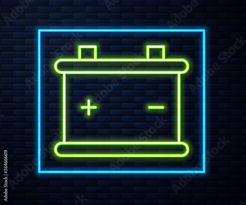 Glowing neon line Car battery icon isolated on brick wall background. Accumulator battery energy power and electricity accumulator battery. Vector Illustration.