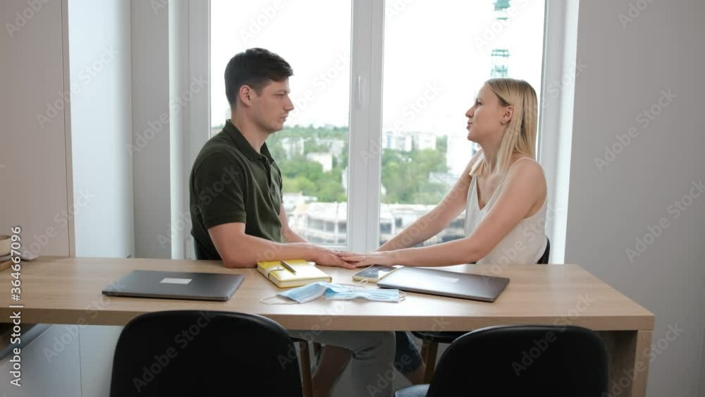 Young couple take a break from work and talking about their family plans. Working from home and stay at home due the pandemic situations concept Young couple take a break from work and talking about their family plans. Working from home and stay at home due the pandemic situations concept