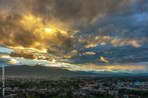 Dramatic sunrise or sunset sky and clouds moving over the mountain and city, Chiang Mai in Thailand.